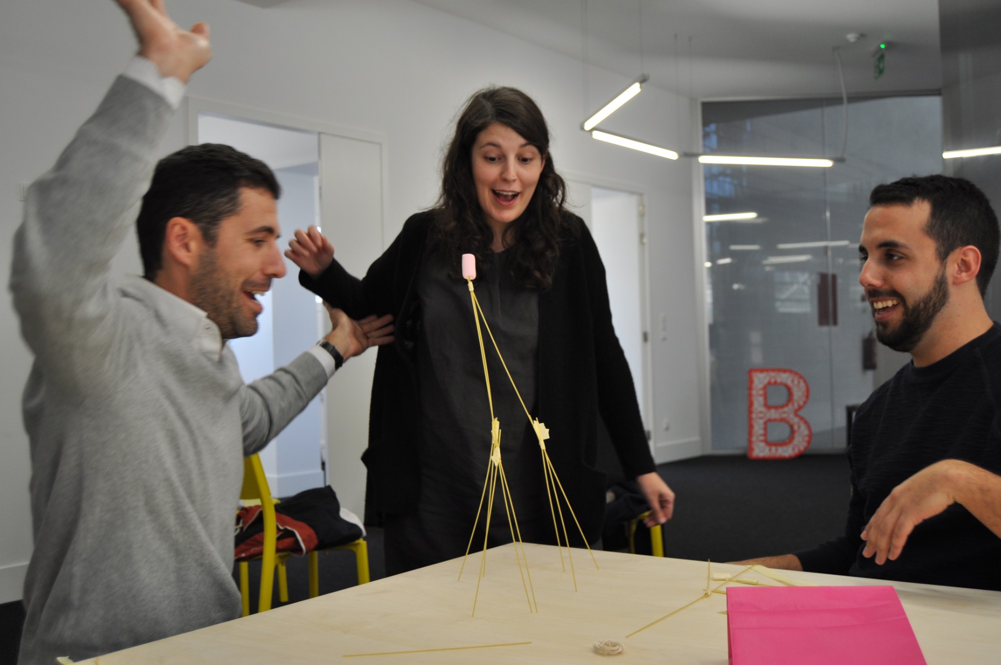 Students cheer as their spaghetti and marshmallow tower stands during the welcome days
