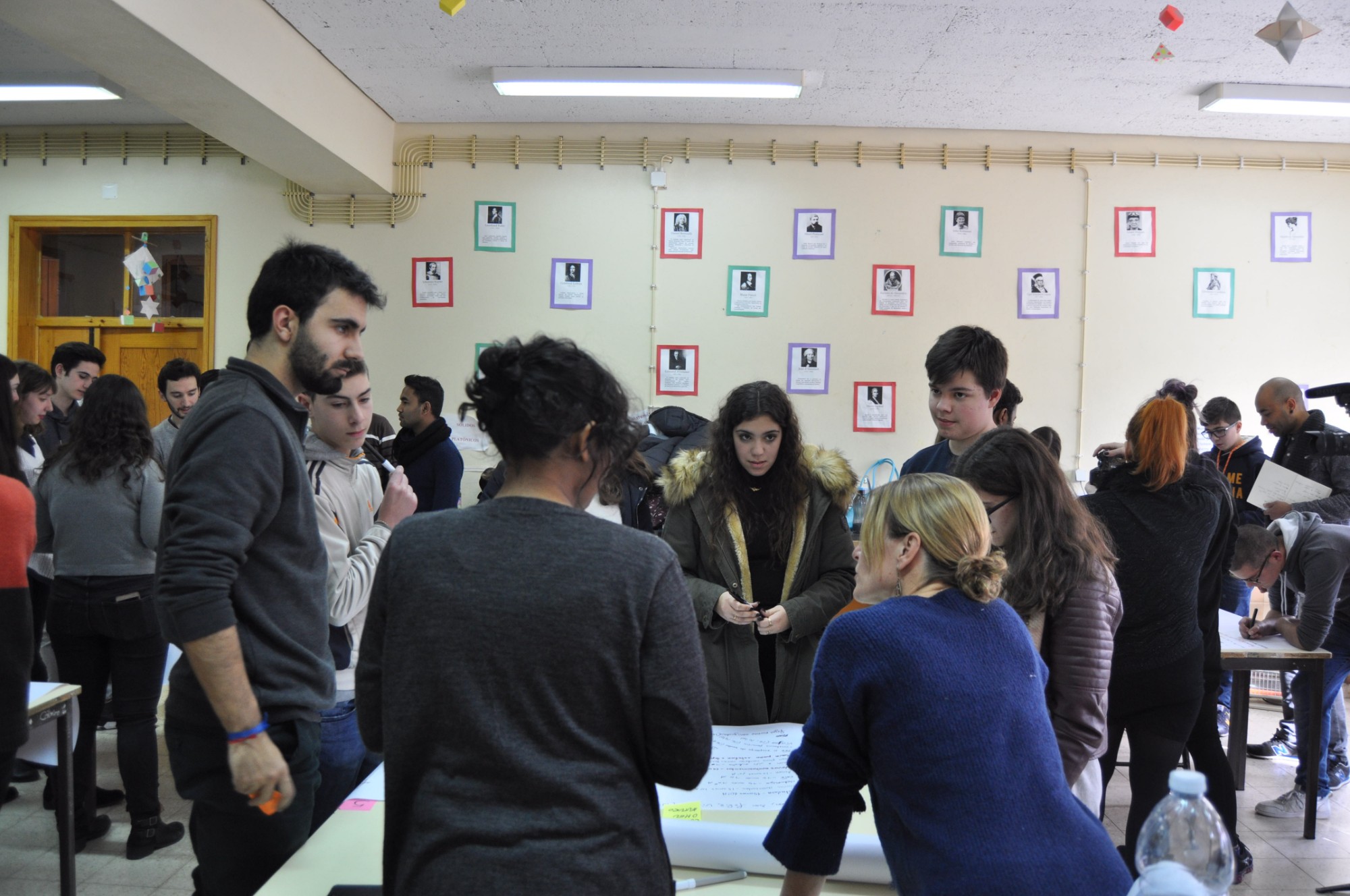 TNDS students run a workshop with local high school students around tables in a school classroom